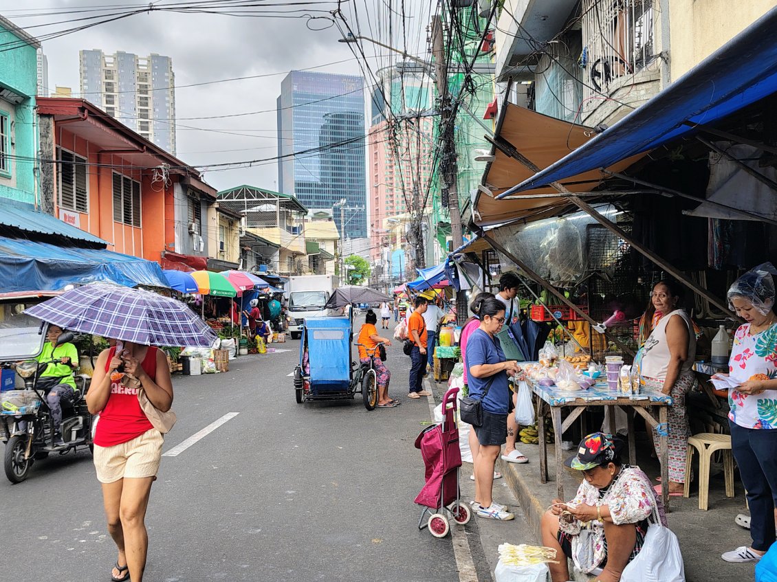 La vie locale traditionnelle côtoie la vie moderne avec ses gratte-ciels.